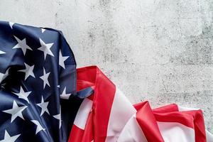 Closeup of American flag on grey textured background top view photo