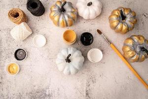 halloween colored pumpkins with paints and a brush top view flat lay photo