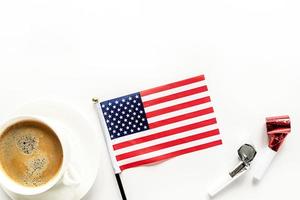 cup of coffee with usa flag and noisemakers isolated on white background photo