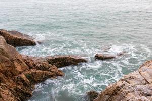 Rocks and waves by the sea photo