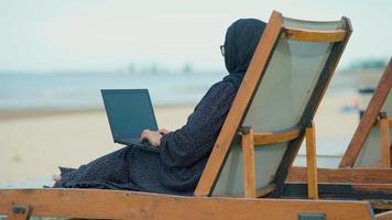 Muslim women sitting outside working according to the slogan work form home She was working in a private residence. video