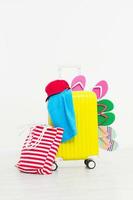 suitcase isolated on white background Summer holidays. summer flip flops or slippers.Sandals beach.Red cap.Travel valise or bag. Mock up. Copy space. Template. Blank. photo