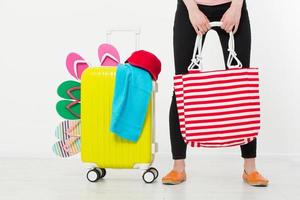 girl with suitcase isolated on white background .Summer holidays. summer flip flops or slippers. Travel valise or bag. Mock up. Copy space. Template. Blank. photo