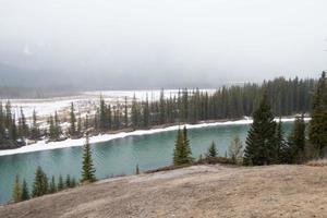 Beautiful aerial view of the river and forest around with snow. Banff National Park, Alberta, Canada photo