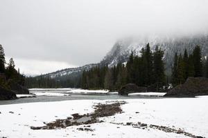 Winter landscape with snowed mountains and river at Banff National Park, Alberta, Canada. photo