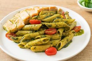 penne pasta in pesto sauce with grilled chicken photo