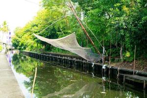 fishing nets hanging on canal photo