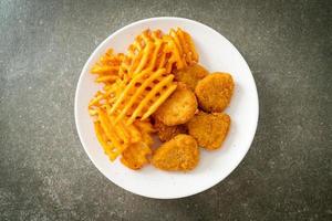 fried chicken nuggets with fried potatoes photo