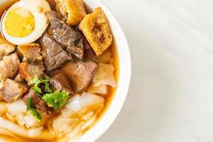 paste of rice flour or boiled Chinese pasta square in clear soup photo