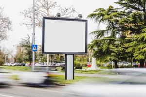 blurred vehicle passing by blank billboard road