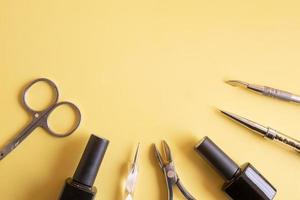 Flat lay manicure tools on a colored background with copy space photo