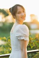 Portrait of a beautiful young Asian girl in the sunset