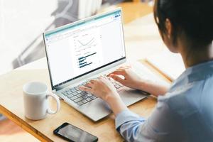 image of a female businessman sitting and working with a laptop photo