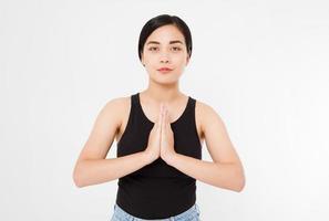 Close-up of hands of black woman in white clothes meditating indoors, focus on arms in Namaste gesture.Mock up. Copy space. Template. Blank. photo