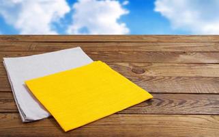 coloured napkins on empty wooden table - top view, copy space photo