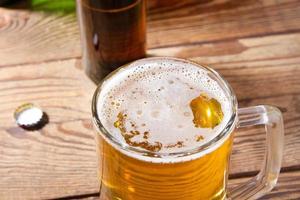 glass of beer on wooden table, top view. Beer bottles. Selective focus. Mock up. Copy space.Template. Blank. photo