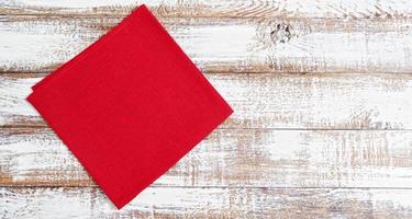 red napkin on wooden table - top view,copy space photo