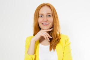 Happy beautiful young red head woman in a stylish yellow jacket copy space. Attractive red hair girl looking away. photo