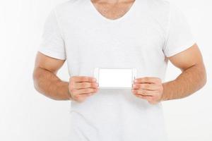 Man holding white phone. Cellular isolated on white clipping path inside. Top view.Mock up.Copy space.Template.Blank. photo