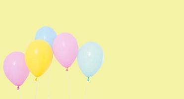 coloured balloon isolated on yellow background, copy space, holiday concept photo