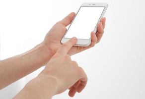 Hand holding white phone isolated on white clipping path inside. Top view.Mock up.Copy space.Template.Blank. photo