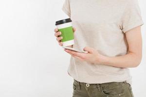 Girl holding white phone.Plastic cup of coffee. Cellular isolated on white clipping path inside. Top view.Mock up.Copy space.Template.Blank. photo