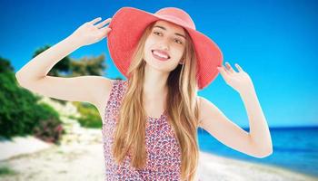 Young happy woman on the beach in summer vacation photo