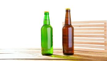 Photo of two different full beer bottles with no labels. Separate clipping path for each bottle included.2 two separate photos merged together. Glass bottles odifferent beer on light white background