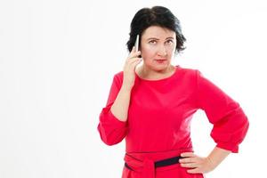 portrait of a worried middle aged woman talking on telephone photo