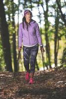 Sporty girl practicing nordic walking photo