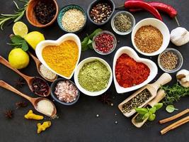 Various spices in a bowls on a black photo