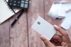 close up of person hand holding credit card photo