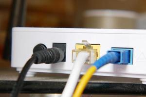 Wi-Fi router with cables on table photo