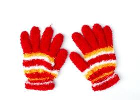 Christmas knitted red gloves isolated on white background above photo