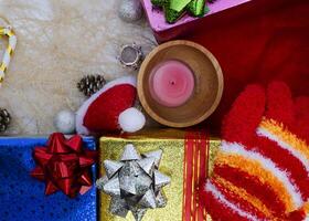 Christmas hat and candle with gift box decoration backgrounds above photo