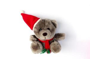 Teddy bear with red hat for Christmas seasonal on white backgrounds photo