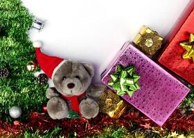 Teddy and gift box with Christmas decoration on white backgrounds above photo