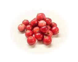 Slide of ripe red cranberries isolated on white background photo