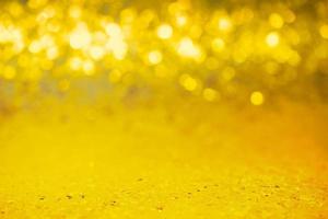 Very narrow focal area of a glitter background. Gold color sequins with defocus light. Christmas. photo
