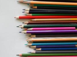Multi-colored pencils on white background photo