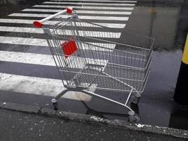 Carts for grocery products stand near a supermarket on the street photo