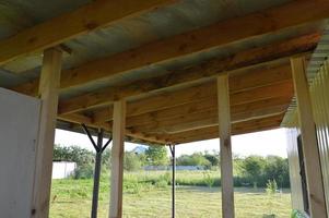 Construction of the vestibule of the veranda of racks and beams photo