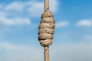 lots of ropes and a big knot against the blue sky photo