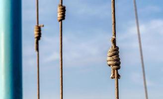 lots of ropes and a big knot against the blue sky photo