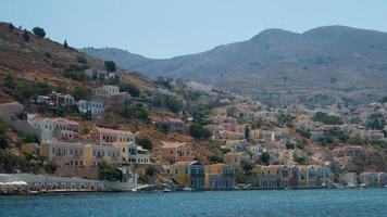 View of Symi island beach and village from the sea. Dodecanese, Greece photo