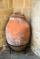 Decorative ancient clay jar with cover. Greek Monastery. photo