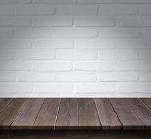 Wood table with White brick wall background photo