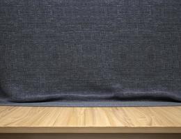 Wood table with grey fabric background photo