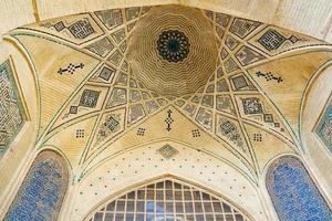 Shiraz, Iran,2016 - Persian dome ceiling brick and mosaic tiles pattern of a building near the Tomb of poet Hafez. photo