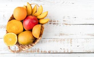 tropical fruit in a basket flat lay top view with copy space photo